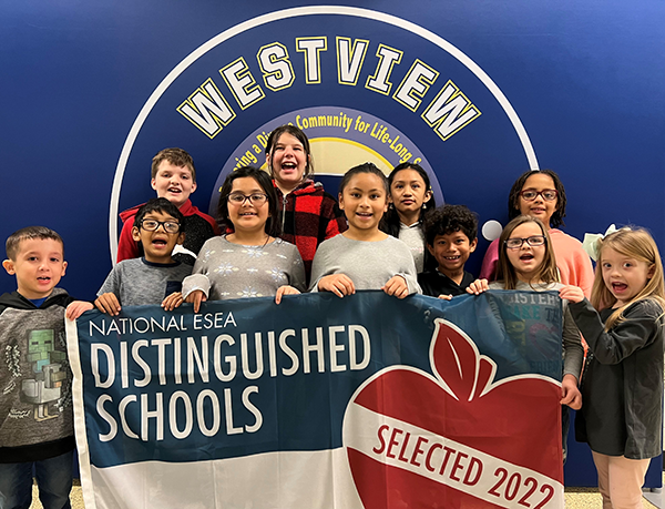 students hold award banner